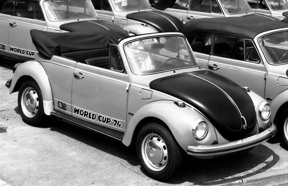 Row of World Cup '74 Super Beetle convertibles with black tops lined up at the Karmann factory in Osnabrück before delivery